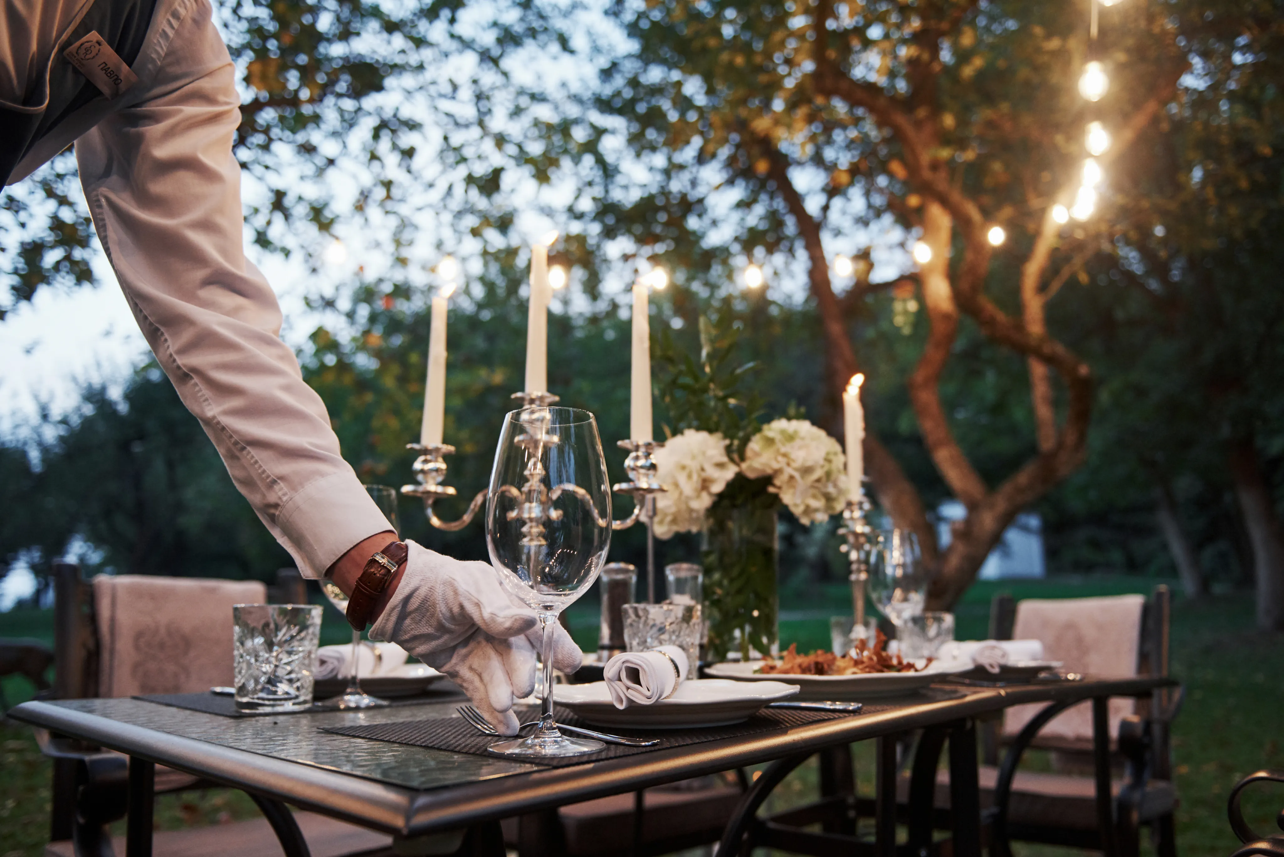 Waiter setting an elegant table — Danon & Co in-house staff