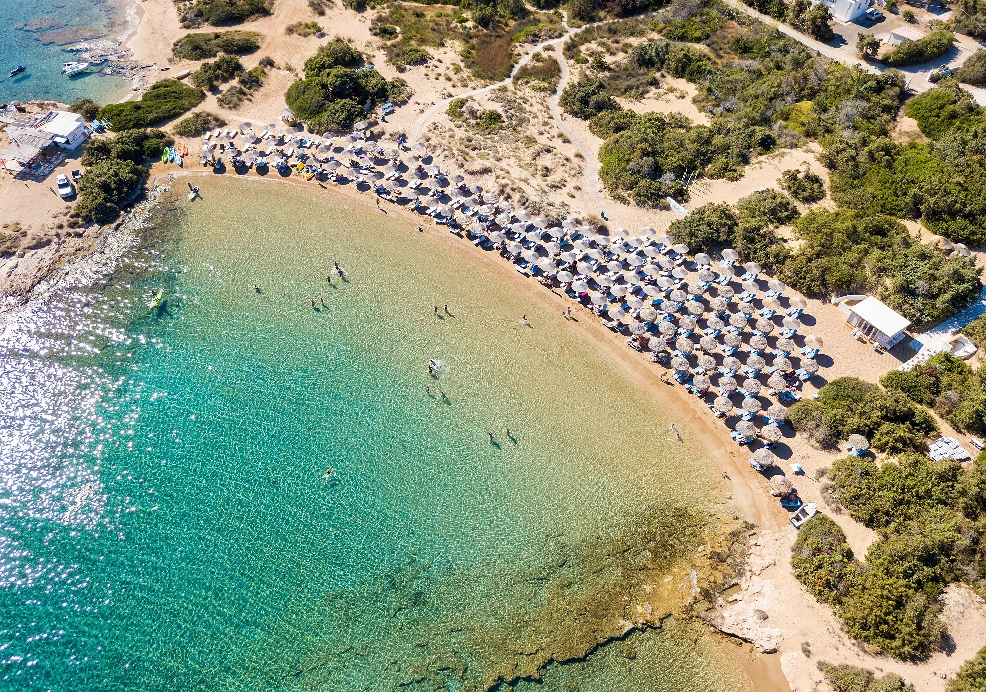 A sandy bay with turquoise water on Paros, from above